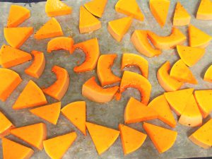 cut pumpkin, toss with oil, salt and pepper, spread onto tray and bake